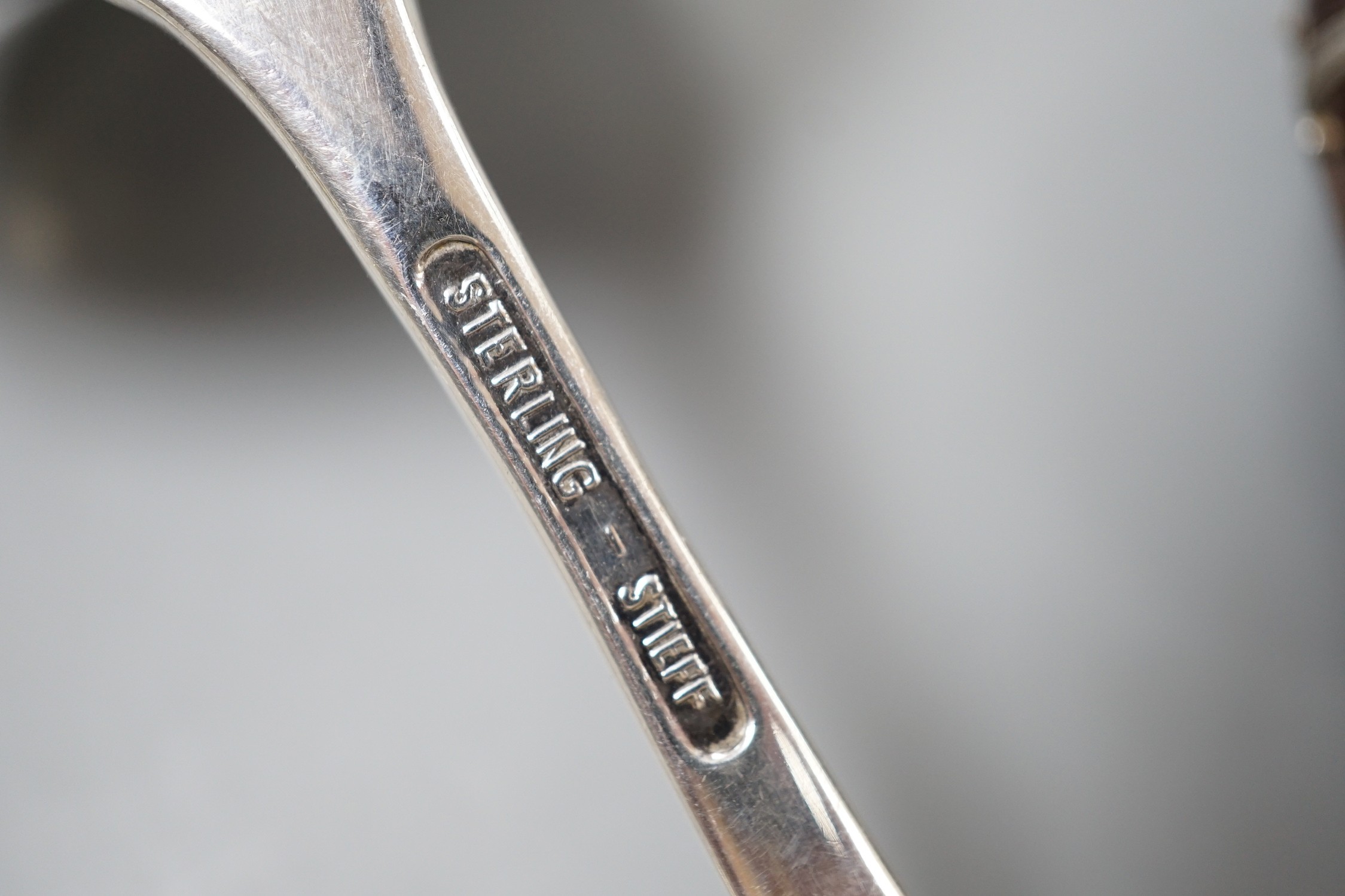 Four assorted early 20th century silver vesta cases, including a silver gilt mounted nut, and patent action circular, together with a sterling vesta case and ornate handled sauce ladle and a mother of pearl handed silver